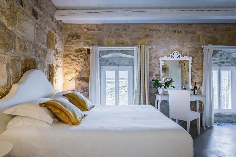  Udobna spavaća soba u kombinaciji prirodnog kamena i belog nameštaja