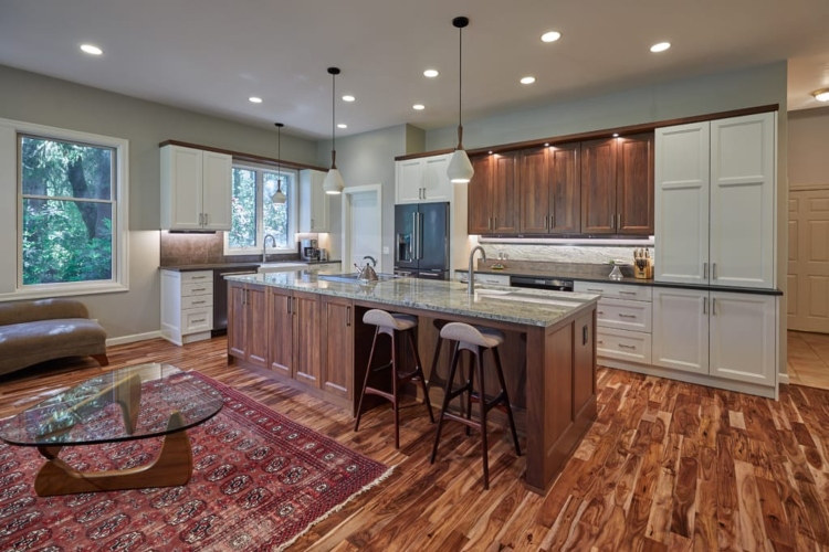  Kuhinja u savremenom stilu sa istaknutim podom od tvrdog drveta i belim ormarićima